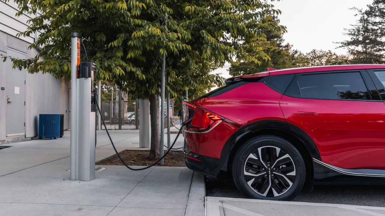 Red Kia EV6 parked at a charger